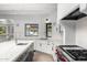 Open concept kitchen showcases stainless appliances, white cabinets, large island with seating, and backyard views at 5838 E Berneil Ln, Paradise Valley, AZ 85253