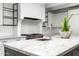 Bright kitchen features marble counters, decorative backsplash, stainless appliances, and a kitchen island with sink at 5838 E Berneil Ln, Paradise Valley, AZ 85253