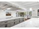 Bright kitchen features marble countertops, white cabinets, stainless appliances, and a long island with seating at 5838 E Berneil Ln, Paradise Valley, AZ 85253