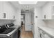 Bright laundry room featuring modern appliances, white cabinetry and tile backsplash at 5838 E Berneil Ln, Paradise Valley, AZ 85253