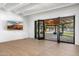 Bright living room boasts tile floors, beamed ceilings, and access to a covered patio and landscaped backyard at 5838 E Berneil Ln, Paradise Valley, AZ 85253