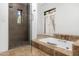 Elegant bathroom with a glass enclosed shower, soaking tub, and stylish window with beautiful tile accents at 5838 E Berneil Ln, Paradise Valley, AZ 85253