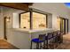 Outdoor kitchen bar with seating provides a fun entertaining area at 5838 E Berneil Ln, Paradise Valley, AZ 85253