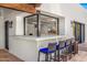 Outdoor bar area with marble countertops and comfortable seating for entertaining guests at 5838 E Berneil Ln, Paradise Valley, AZ 85253