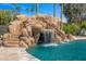Backyard pool with custom waterfall and slide at 5838 E Berneil Ln, Paradise Valley, AZ 85253