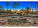 Resort-style pool with rock waterfall, water slide, and fire pit, creating an outdoor oasis at 5838 E Berneil Ln, Paradise Valley, AZ 85253