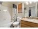 Cozy bathroom features a combined bathtub and shower, toilet, and a vanity with a sink at 5839 W Ironwood Dr, Glendale, AZ 85302