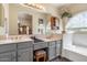 Bathroom vanity with double sinks, neutral walls, and a window providing natural light at 5839 W Ironwood Dr, Glendale, AZ 85302
