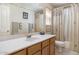 Neutral bathroom with a large mirror, a single sink, and a shower with an off-white curtain at 5839 W Ironwood Dr, Glendale, AZ 85302