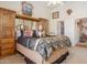 Bedroom featuring large armoire, king bed, and open closet at 5839 W Ironwood Dr, Glendale, AZ 85302