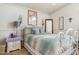 Cozy bedroom with decorative metal bed frame, side table, and large mirror at 5839 W Ironwood Dr, Glendale, AZ 85302