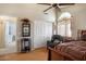 Well-lit bedroom with wood floors, a recliner chair, and private bathroom access at 5839 W Ironwood Dr, Glendale, AZ 85302