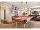 Game room boasts a pool table, comfortable leather seating, and open access to other living areas at 5839 W Ironwood Dr, Glendale, AZ 85302