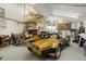 Spacious garage featuring vintage race car, ladder, and plenty of room to work at 5839 W Ironwood Dr, Glendale, AZ 85302