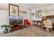 Comfortable living space with a large TV, a red accent chair, and a dedicated workspace at 5839 W Ironwood Dr, Glendale, AZ 85302