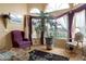 Inviting living room with tall windows, hardwood floors, and charming décor at 5839 W Ironwood Dr, Glendale, AZ 85302
