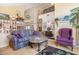 Inviting living room with tall windows, hardwood floors, and charming décor at 5839 W Ironwood Dr, Glendale, AZ 85302