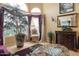 Inviting living room with tall windows, hardwood floors, and charming décor at 5839 W Ironwood Dr, Glendale, AZ 85302