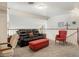 Cozy upstairs living area with a dark leather sofa and a complementary red ottoman at 5839 W Ironwood Dr, Glendale, AZ 85302