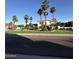 Charming two-story home featuring lush landscaping, a well-manicured lawn, and elegant curb appeal with mature palm trees at 6337 W Deer Valley Rd, Glendale, AZ 85308