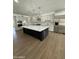 Spacious kitchen featuring a large island with seating, quartz countertops, and stainless steel appliances at 6337 W Deer Valley Rd, Glendale, AZ 85308