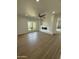 Stylish living room featuring wood-look tile flooring, a modern fireplace, and ample natural light at 6337 W Deer Valley Rd, Glendale, AZ 85308