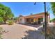Expansive backyard with covered patio and low-maintenance desert landscaping at 67 N Montoro Ln, Casa Grande, AZ 85194
