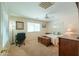 Comfortable bedroom with natural light, carpeting, fan, and home office at 67 N Montoro Ln, Casa Grande, AZ 85194