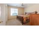 Cozy bedroom with natural light, carpet, ceiling fan and comfortable furnishings at 67 N Montoro Ln, Casa Grande, AZ 85194