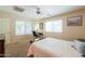Bedroom featuring a ceiling fan, natural light, and home office with desk and chair at 67 N Montoro Ln, Casa Grande, AZ 85194