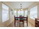 Cozy dining room with a wooden table, cushioned chairs, and bright natural light at 67 N Montoro Ln, Casa Grande, AZ 85194