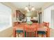 Inviting dining area with ample light, a wooden table, and comfortable seating for Gathering meals at 67 N Montoro Ln, Casa Grande, AZ 85194