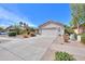 Single-story home with a two-car garage, desert landscaping, and a spacious driveway at 67 N Montoro Ln, Casa Grande, AZ 85194