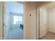 Hallway leading to bedrooms with tile flooring, lots of light and neutral color palette at 67 N Montoro Ln, Casa Grande, AZ 85194