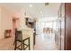 Well-lit kitchen featuring a breakfast bar, stainless steel appliances, and dark wood cabinetry at 67 N Montoro Ln, Casa Grande, AZ 85194