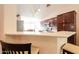 Stylish kitchen with granite countertops, modern lighting, and a breakfast bar at 67 N Montoro Ln, Casa Grande, AZ 85194