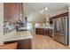 Gourmet kitchen with a stainless steel refrigerator, mosaic backsplash, and an open layout at 67 N Montoro Ln, Casa Grande, AZ 85194