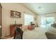 Bright living room with beige walls, an entertainment center, and sliding glass doors to the patio at 67 N Montoro Ln, Casa Grande, AZ 85194