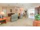 Open living room with neutral colors, comfortable seating, and a seamless flow to the dining and kitchen areas at 67 N Montoro Ln, Casa Grande, AZ 85194