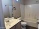 Well lit bathroom with a combination shower-bath and a white vanity with a single sink at 720 W Lydia Ln, Phoenix, AZ 85041