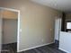 Well-lit bedroom has laminate floors, two white doors, and a window bringing in natural light at 720 W Lydia Ln, Phoenix, AZ 85041