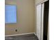Bedroom showcasing a window, sliding-door closet, and gray wood flooring at 720 W Lydia Ln, Phoenix, AZ 85041