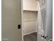 Walk-in closet featuring gray wood floors, neutral walls, and a wooden clothes rack at 720 W Lydia Ln, Phoenix, AZ 85041