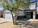 Two story house with a white garage door, covered car port, and well-maintained landscaping at 720 W Lydia Ln, Phoenix, AZ 85041