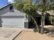 Exterior view of home featuring the two-car garage and covered entry way and neat landscaping at 720 W Lydia Ln, Phoenix, AZ 85041