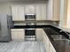 The kitchen features stainless steel appliances, granite countertops, modern cabinets, and tile flooring at 720 W Lydia Ln, Phoenix, AZ 85041