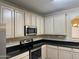 Bright kitchen features stainless steel appliances, black countertops and ample cabinet space at 720 W Lydia Ln, Phoenix, AZ 85041