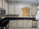 Bright kitchen showcases stainless steel appliances, tile floors, and black countertops at 720 W Lydia Ln, Phoenix, AZ 85041