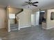 Bright open-concept living room showcases the staircase, tile floors, and seamless flow into the kitchen at 720 W Lydia Ln, Phoenix, AZ 85041