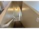 Interior stairway leading down to the lower level with neutral walls and carpeted steps at 720 W Lydia Ln, Phoenix, AZ 85041